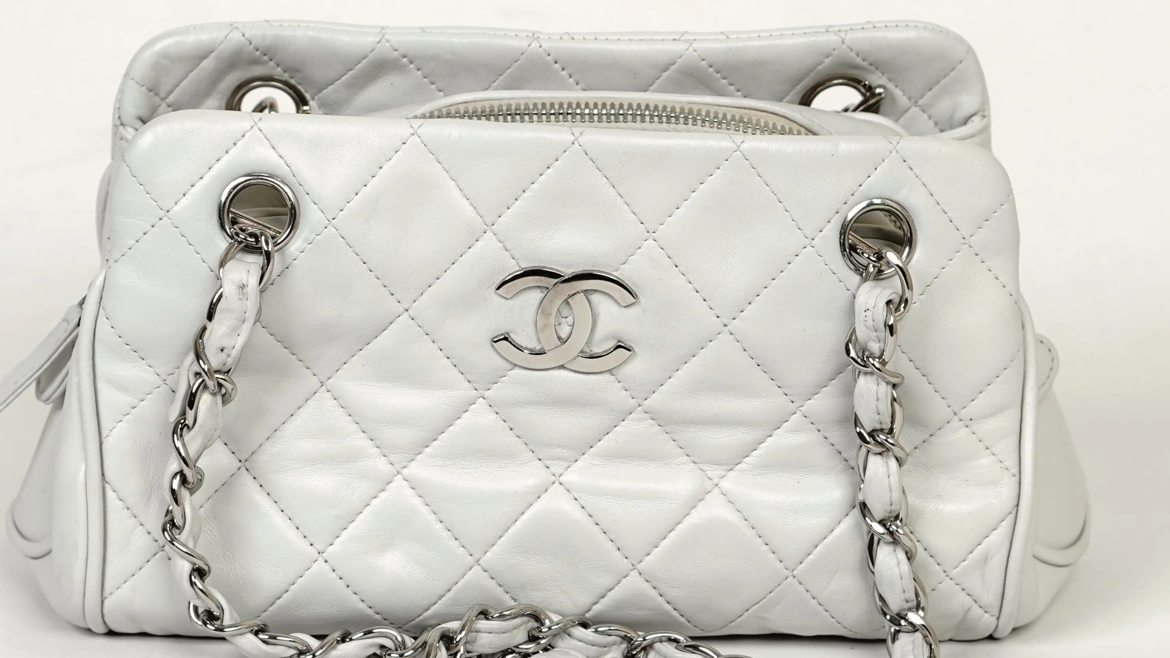 Before Chanel handbag restoration faded tone with surface dullness and wear