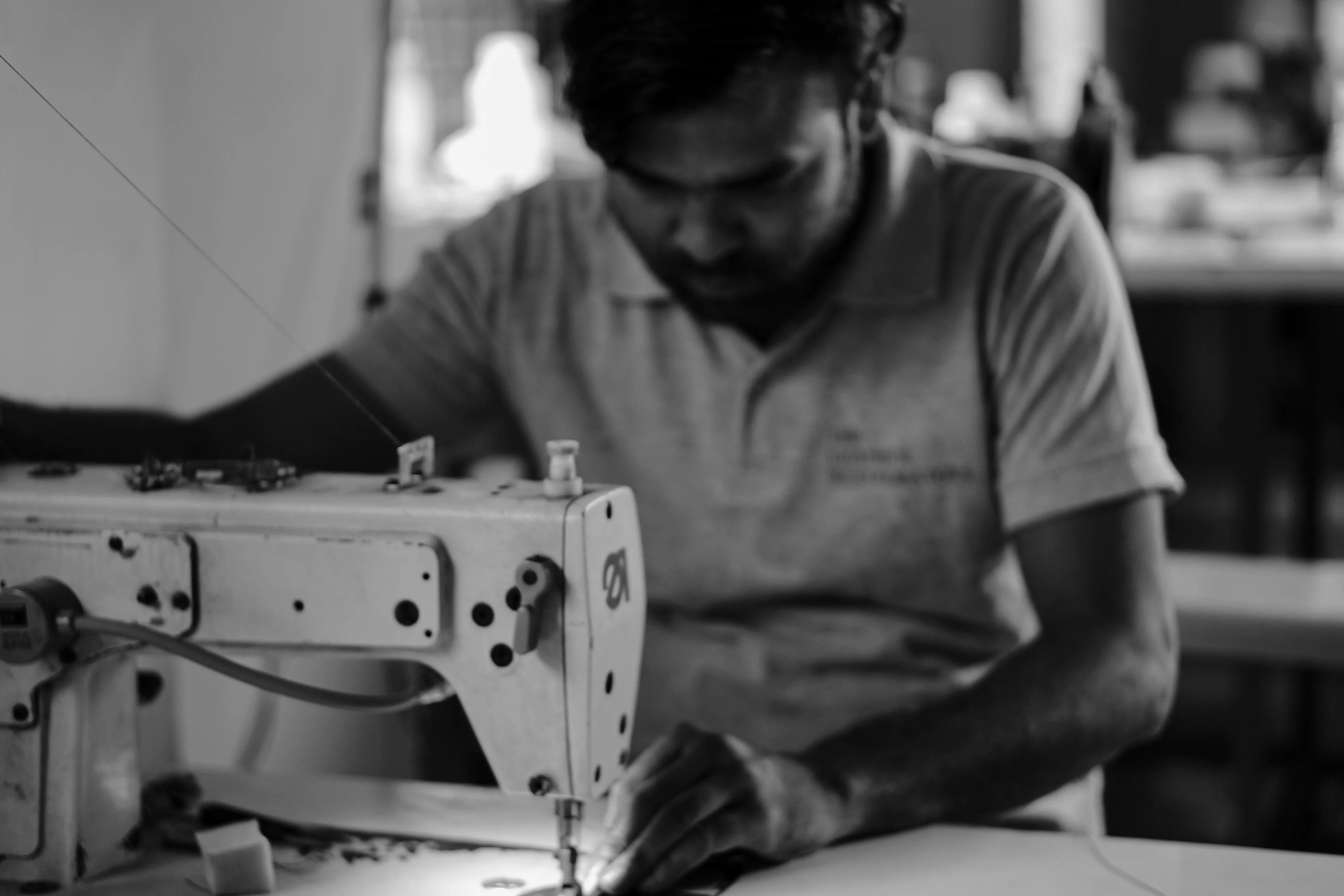 Artisan restoring Hermès and Saint Laurent leather jackets at The Leather Restorators atelier in Delhi NCR
